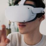 Potential, Augmented Reality - Young male interacting with virtual reality headset in apartment