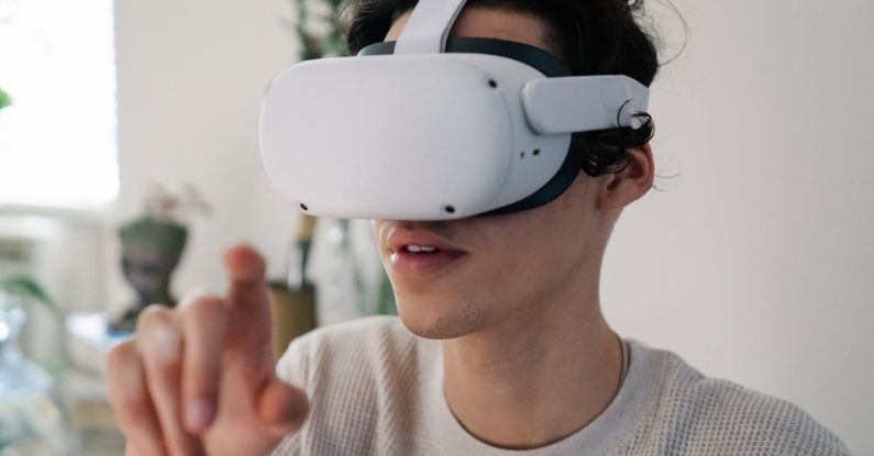 Potential, Augmented Reality - Young male interacting with virtual reality headset in apartment