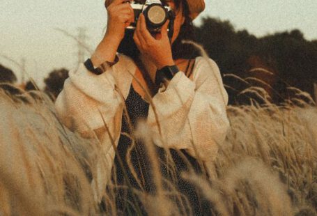 Failure, Professional Growth - Unrecognizable female photographer taking photo on camera in field