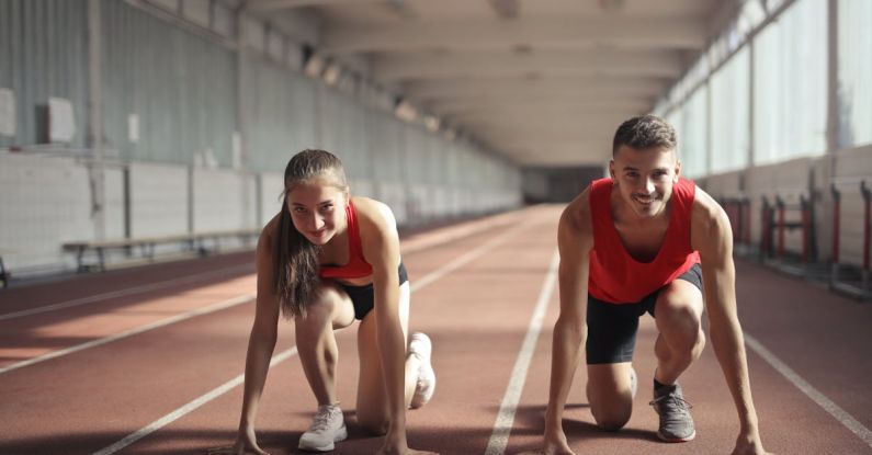 Problem-solving, Skills - Men and Woman in Red Tank Top is Ready to Run on Track Field