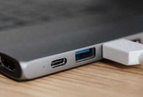 Adaptability, Workplace - USB type c multiport adapter with plugged white cable connected to modern laptop