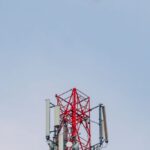 Technology, Industries - A cell tower with a green leaf in the background