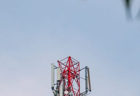 Technology, Industries - A cell tower with a green leaf in the background