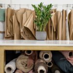 Innovation, Fashion Industry - Rolls of assorted fabrics and textiles and sewing patterns inside tailor atelier